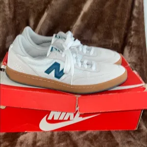 New Balance White and Blue Sneakers