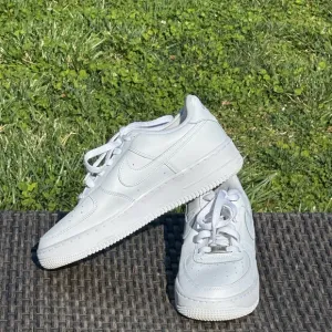Nike Air Force 1 White Sneakers with Textured Leather and Slim Profile