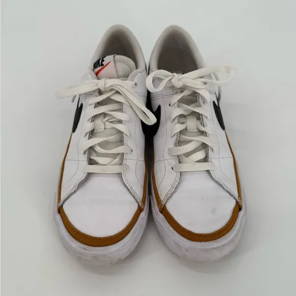 Nike White and Black Sneakers with Prominent Swoosh and Comfortable Midsole