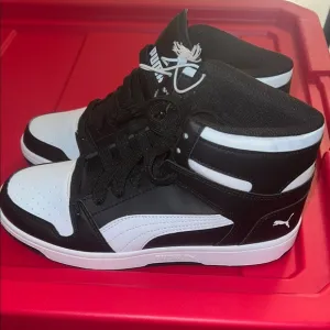 Puma Black and White Sneakers with Chunky Collar and Retro Style